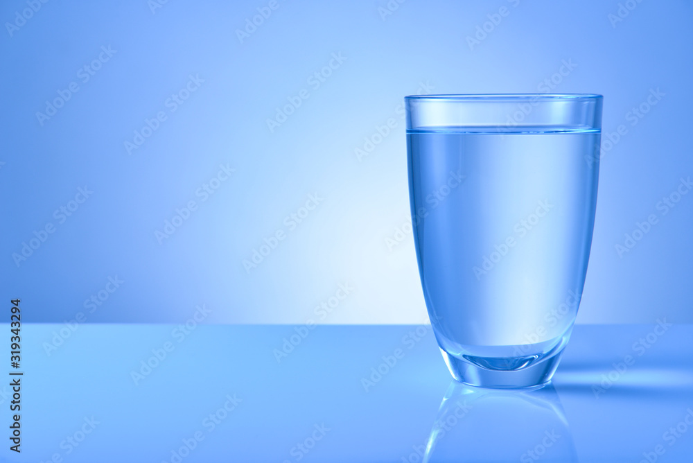 Glass of fresh water on color background