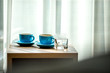 Blurred background view of a mug or coffee cup, a cup of water or a drink on the table, for customer service in a room or restaurant