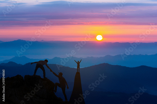 Cuadros en Lienzo Teamwork friendship hiking help each other trust assistance silhouette in mountains, sunrise