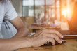 © weerachai - businessman typing with laptop.working at coffee shop.Prepare a proposal to the Special Project Director.