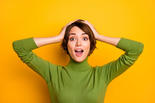 Closeup Photo Of Funny Short Hairdo Lady Good Mood Listen Positive News Open Mouth Arms On Head Wear Casual Green Turtleneck Warm Sweater Isolated Yellow Color Background