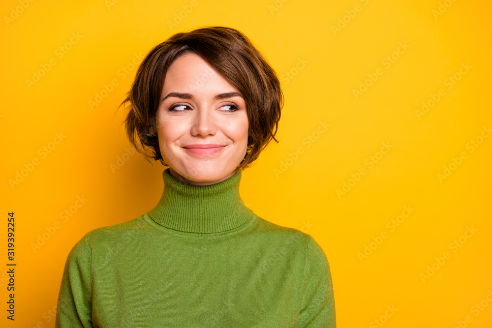 Closeup photo of funny short hairdo lady charming smiling good mood looking side empty space sly eyes wear casual green warm turtleneck isolated yellow color background - obrazy, fototapety, plakaty 