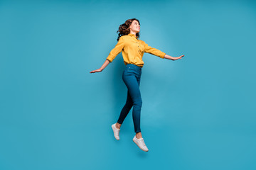 Full length body size view of her she nice attractive lovely pretty cheerful cheery wavy-haired girl jumping strolling isolated on bright vivid shine vibrant green blue turquoise color background