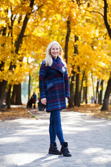 Wall Mural - Portrait of a young beautiful woman in blue coat