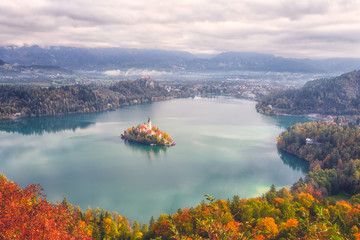 Wall Mural - Famous alpine Bled lake (Blejsko jezero) in Slovenia, amazing autumn landscape. Aerial view of the lake, island with church, Bled castle and Julian Alps, outdoor travel background