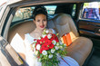 © Екатерина Переславце - bride with a bouquet of flowers sitting in the car