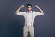 © deagreez - Don't forget about gym training. Photo of macho business man raise two big biceps dressed formalwear white shirt beige suspenders trousers isolated grey color background