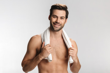 Wall Mural - Photo of happy half-naked man posing with towel and smiling