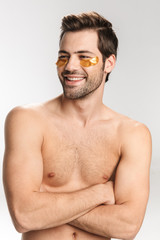 Wall Mural - Photo of happy half-naked man looking at camera and smiling