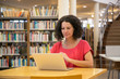 © Mangostar - Focused beautiful woman looking at laptop while sitting at table. Concentrated mature student studying with laptop. Technology, education concept
