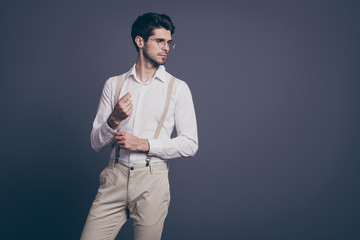 Wall Mural - Portrait of his he nice attractive imposing elegant luxurious focused brunette man macho fixing button looking aside posing isolated on grey pastel color background