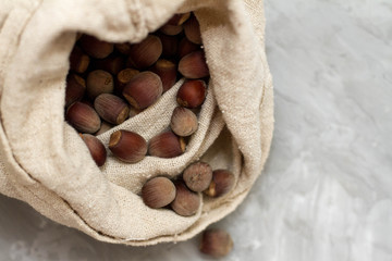 Wall Mural - hazelnut lies on a dark background. the bag is full of nuts. the concept of proper nutrition and health, vitamins. the view from the top, place for your text. health food.