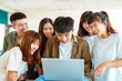 © Tom Wang - excited college students looking at laptop  in classroom