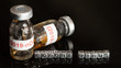 © Unshu - Vaccine bottle labeled '(2019-nCoV)  and Taxt 'corona virus' put on black background.  Concept Plague from China Or the corona virus.