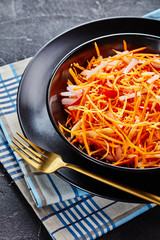 Canvas Print - Fresh carrot salad in a black bowl