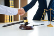 © Pichsakul - Judge And Client Shaking Hands after agreeing to enter into a contract for a court case In A Courtroom, legal services concept