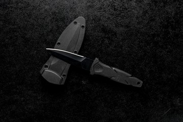 Poster - Closeup shot of a fixed sharp knife on a black background