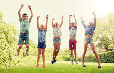 Poster - friendship, childhood, leisure and people concept - group of happy kids or friends jumping up and having fun in summer park