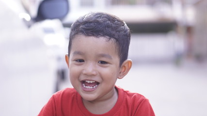 Portrait of cute happy boy close-up of smiley face. Little kid 2 year old show his white tooth. 