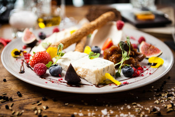 Cheese platter for two served on a plate in restaurant