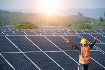 Wall Mural - solar cell power engineer technician checks the maintenance of the solar panels.
