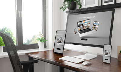 black and white desktop with three devices showing responsive website