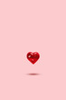 Glass heart on a pastel background, levitation. Symbol of love, minimalism. Concept of love, Valentine's Day