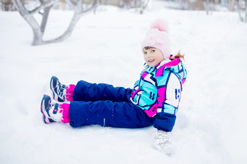 Wall Mural - Cute little girl outdoors on a sunny winter day.