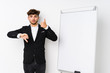 © Asier - Young business coaching arabian man showing thumbs up and thumbs down, difficult choose concept