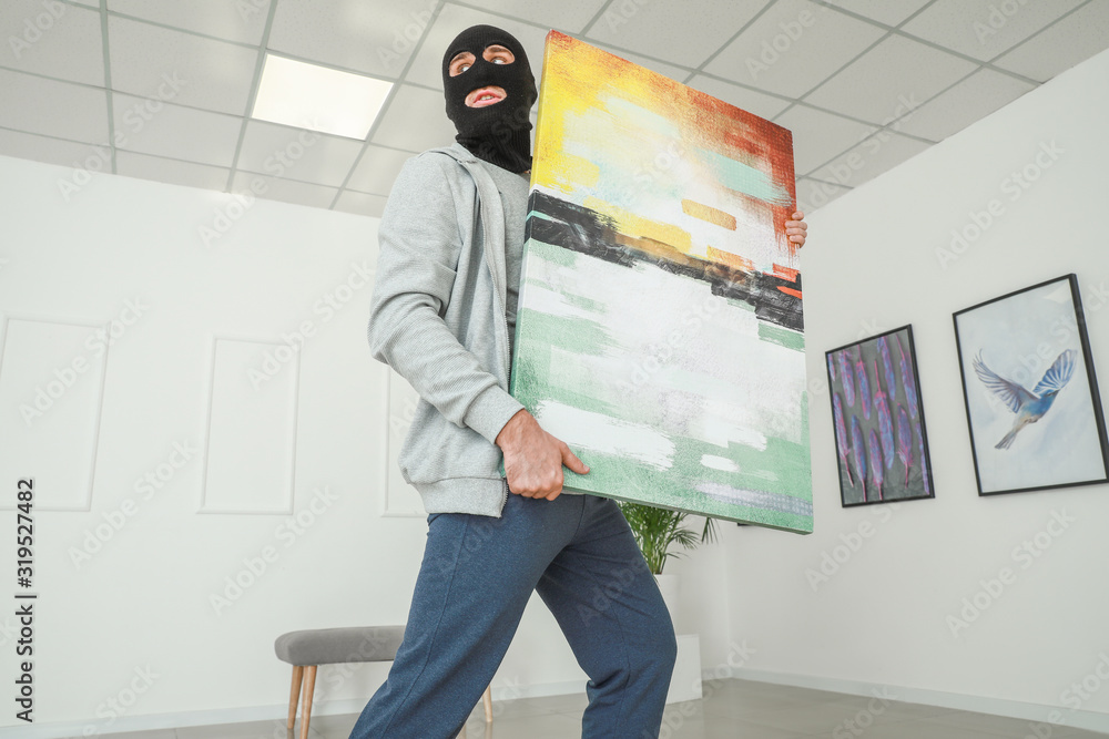 Thief stealing picture from art gallery