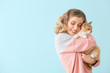 © Pixel-Shot - Beautiful young woman with cute cat on color background