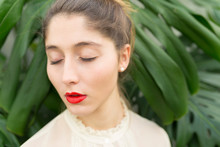 Portrait Of Young Woman With Red Lips And Eyes Closed Relaxing