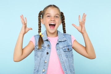 Wall Mural - Young happy girl on blue background