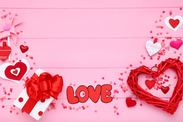 Wall Mural - Valentine hearts with gift box and word Love on pink wooden table