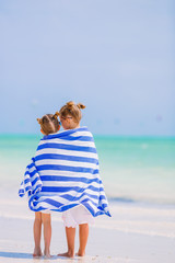 Wall Mural - Little girls having fun enjoying vacation on tropical beach