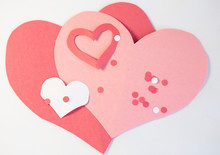 Pink, Red And White Construction Paper Valentine Craft Hearts With "I Love You" Message Written By A Child