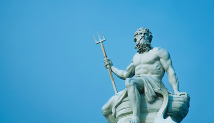 ancient stone statue of mighty god of the sea and oceans neptune (poseidon) with trident.
