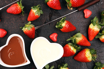 Wall Mural - Valentine Chocolate fondue melted with fresh strawberries and dark and white chocolate. Red roses and sugar hearts for Valentines Day. Valentine Background