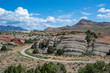 USA, Nevada, Nye County, Basin and Range National Monument, White River Valley. A dirt road curves around brightly colored volcanic tuff rocks.