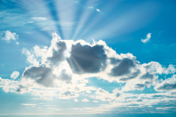 Wall Mural - beautiful blue sky with sunbeams and sun rays through clouds