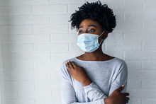 Portrait Of Young African-American Woman Wearing Disposable Medical Face Mask