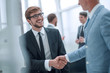 © ASDF - smiling businessman shaking hands with his business partner