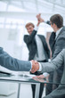 © ASDF - close up. business handshake in a modern office .