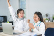 © smolaw11 - Happy medical student,Online doctoring,asian teenage doctor intern working healthcare medical teamwork in online treatment results satisfactory on laptop desk consultation in hospital with stethoscope