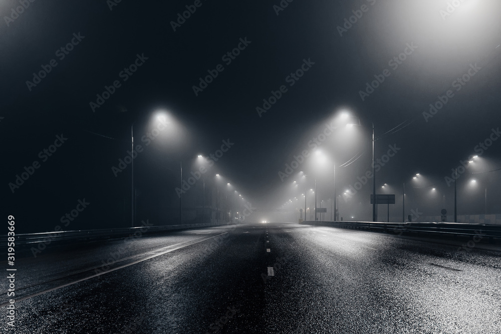 Foggy misty night road illuminated by street lights - obrazy, fototapety, plakaty 