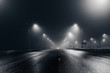Leinwandbild Motiv Foggy misty night road illuminated by street lights