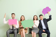 © Pixel-Shot - Group of business people with blank speech bubbles on color background