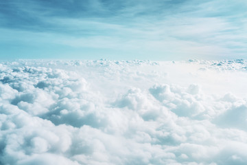 Wall Mural - airplane window view above beautiful white cloud summer blue sky and sun light abstract nature.