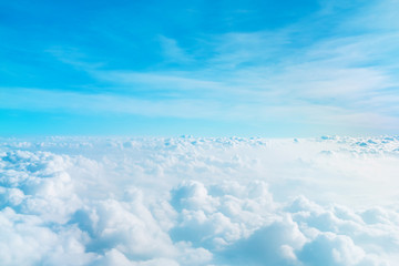 Wall Mural - airplane window view above beautiful white cloud summer blue sky and sun light abstract nature.