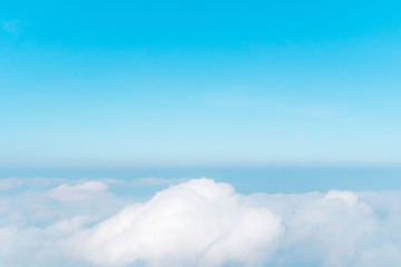 Wall Mural - airplane window view above beautiful white cloud summer blue sky and sun light abstract nature.